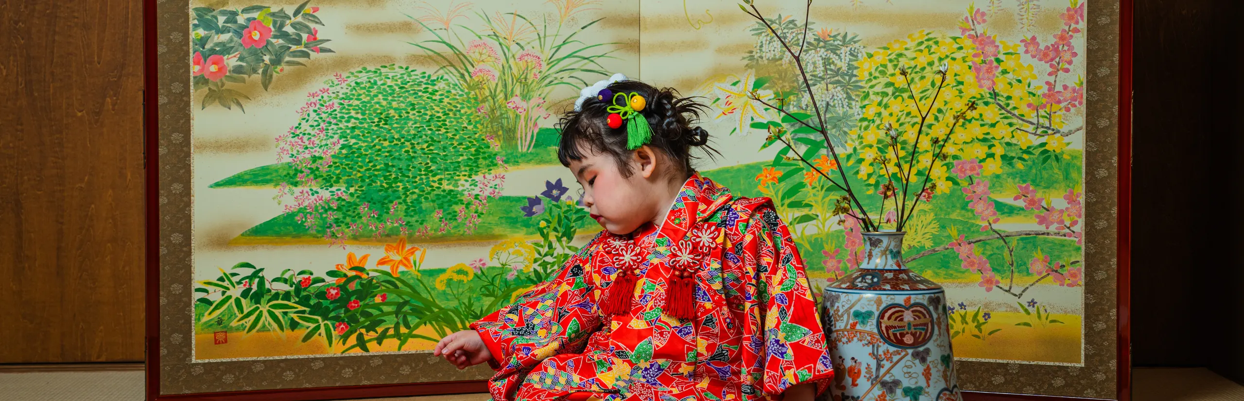 花鳥の屏風を背景に赤い着物で座る七五三の女の子（Byobu シーン）